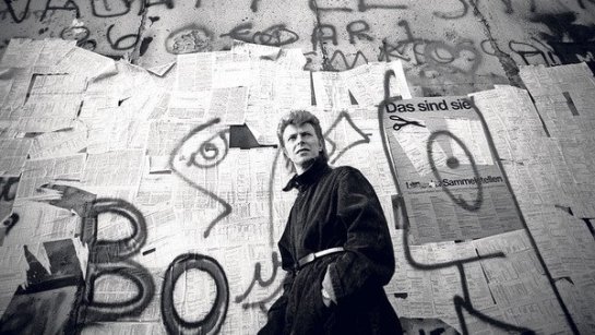 "In 1987, Bowie returned to the divided city to perform for a crowd of 70,000 fans, their sparklers and candles glittering around the Reichstag. Towards the end of the show he read aloud a message in German. “We send our best wishes to all our friends who are on the other side of the Wall.” Then he sang “Time will Crawl”. On the other side of the hateful divide, hundreds of young East Berliners strained to hear echoes of the concert. They caught sight of stage lights flashing off blank, bullet-marked walls. They heard Bowie greet them. They listened to his song. Their song. Berlin’s song. “We can be heroes, just for one day,” he sang in a daring, ironic elegy to both the divided world and his past life.  As “Time will Crawl” reached its climax some of the East German crowd pushed towards the Brandenburg Gate, whistling and chanting, “Down with the Wall”. They threw insults and bottles at the Volkspolizei, rising together in a rare moment of protest. On stage Bowie heard the cheers from the other side. He was in tears." Read full article: The Berlin landmarks that inspired David Bowie  http://www.ft.com/cms/s/2/b20113b0-8753-11e3-9c5c-00144feab7de.html#axzz2s3ZrCQb6